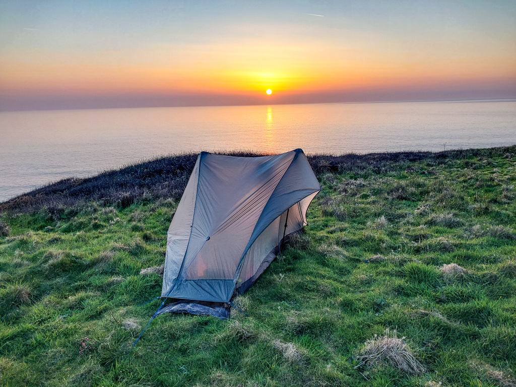 <center>2504-0033 - Tent on cliffs near Watergate Beach with sunset -  April 06, 2025  <br>  (1/150 sec at f / 1.8 ISO 20    4 mm) </center>